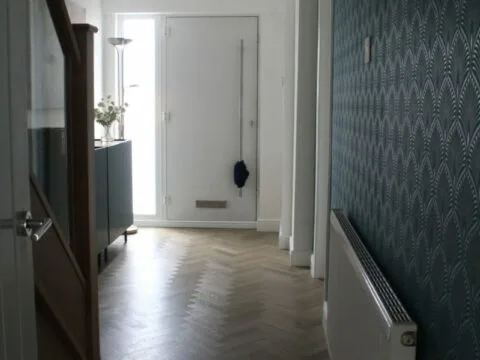 Now the hallway is bright and airy, featuring a striking glass banister that adds a touch of elegance and openness.