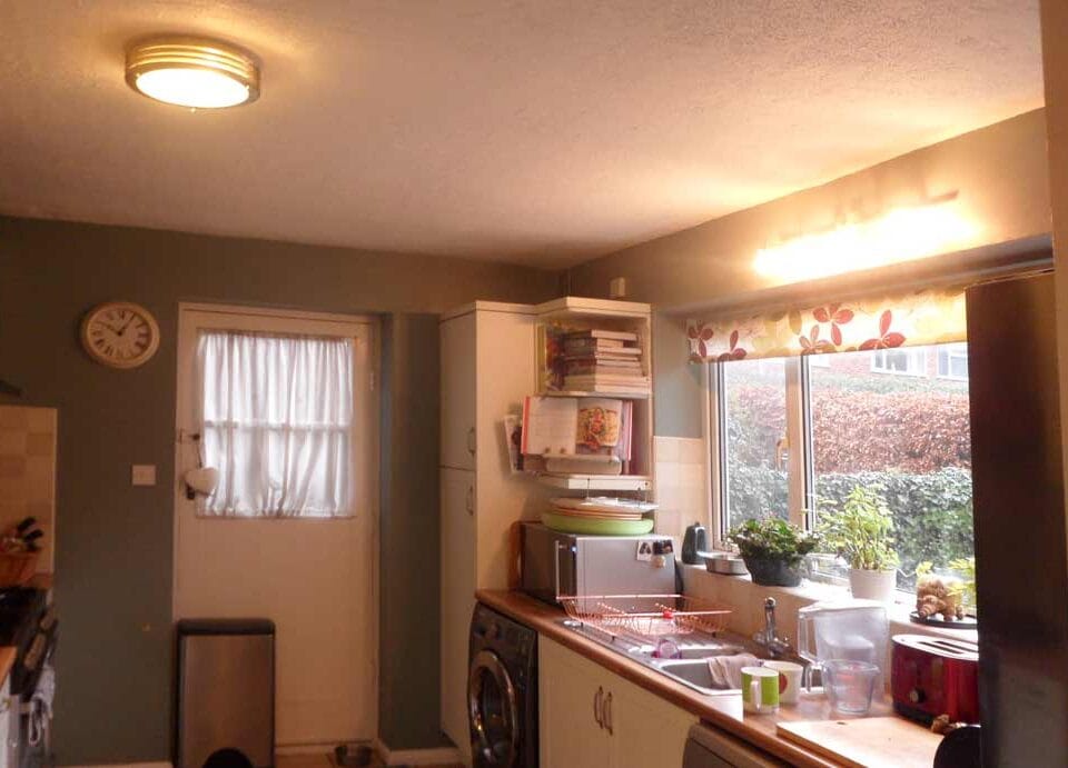 Before Extension with small, cluttered and dark kitchen