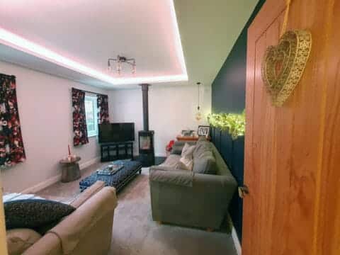 Snug room house renovation with sofa and fire